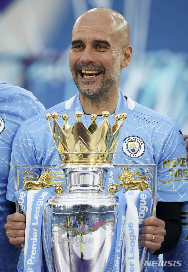 [맨체스터=AP/뉴시스]맨체스터 시티 펩 과르디올라 감독이 23일(현지시간) 영국 맨체스터의 에티하드 경기장에서 열린 2020-21시즌 잉글랜드 프로축구 프리미어리그(EPL) 38라운드 에버튼과의 최종전을 마친 후 우승컵을 들고 웃음짓고 있다. 이미 우승이 확정됐던 맨시티는 아구에로의 멀티 골 등을 묶어 에버튼에 5-0으로 완승했다. 2021.05.24.