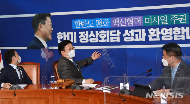 [서울=뉴시스]김진아 기자 = 송영길 더불어민주당 대표가 24일 오전 서울 여의도 국회에서 열린 최고위원회의에 앞서 한미정상회담 성과를 담은 배경막을 보며 이야기하고 있다. (공동취재사진) 2021.05.24. photo@newsis.com