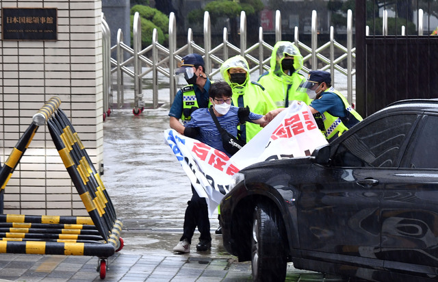 [부산=뉴시스]하경민 기자 = 한국대학생진보연합 소속 청년들이 3일 오전 부산 동구 일본총영사관 앞에서 출근하는 영사 차량을 가로막은 채 기습시위를 벌이고 있다. 이들은 "독도가 일본 땅이라는 도쿄올림픽과 일본 정부 강력 규탄한다'고 밝혔다. 2021.06.03. yulnetphoto@newsis.com