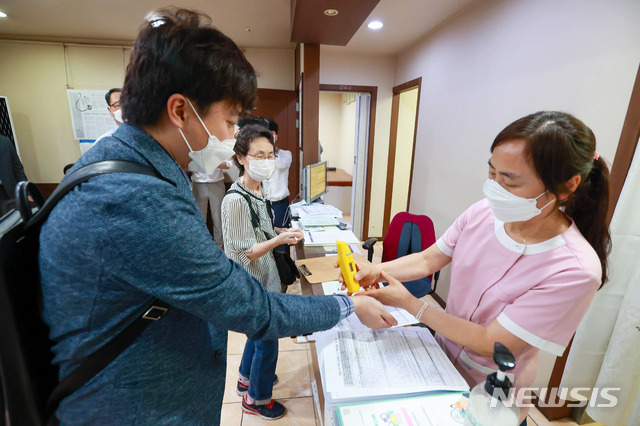 [서울=뉴시스]국회사진기자단 = 이준석 국민의힘 대표가 15일 오전 서울 노원구 한 병원에서 코로나19 백신(얀센) 접종 전 체온측정을 받고 있다. 2021.06.15. photo@newsis.com