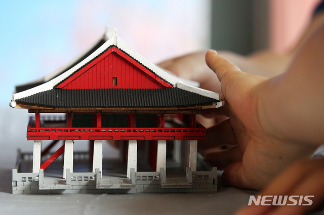 [서울=뉴시스]정병혁 기자 = 25일 오전 서울 종로구 경복궁을 찾은 시각장애인들이 경회루 모형을 만져보며 관람교육을 받고 있다. 이날 문화재청 경복궁관리소는 경복궁 촉각그림카드와 모형을 활용해 경복궁을 관람하는 시각장애인 맞춤형 문화탐방 체험프로그램을 진행했다. 2021.06.25. jhope@newsis.com