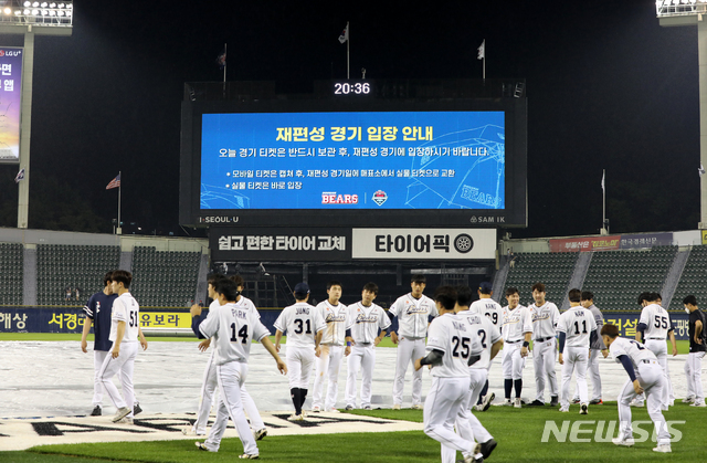 [서울=뉴시스]고범준 기자 = 27일 오후 서울 송파구 잠실야구장에서 열린 2021 KBO리그 두산 베어스와 롯데 자이언츠의 경기, 7회초 3-2로 롯데가 앞선 상황에서 우천으로 중단된 후 서스펜디드 게임으로 선언됐다. 선수들이 경기장을 나가고 있다. 2021.06.27. bjko@newsis.com