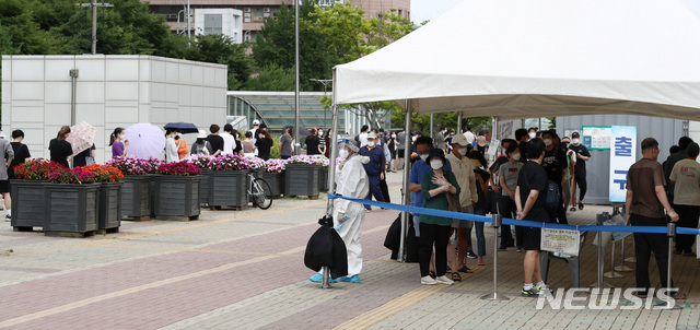 [서울=뉴시스] 이영환 기자 = 코로나19 신규 확진자가 1212명 발생한 7일 오전 서울 마포구 서강대역 광장에 마련된 임시선별검사소에서 시민들이 검사를 받기 위해 줄지어 서 있다. 2021.07.07. 20hwan@newsis.com