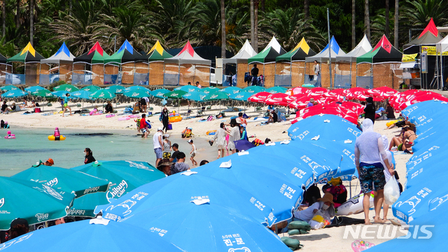 [제주=뉴시스] 우장호 기자 = 사실상 장마가 종료돼 무더운 날씨를 보이는 15일 오후 제주시 한림읍 금능해수욕장을 찾은 관광객들이 물놀이를 하며 더위를 식히고 있다. 2021.07.15. woo1223@newsis.com