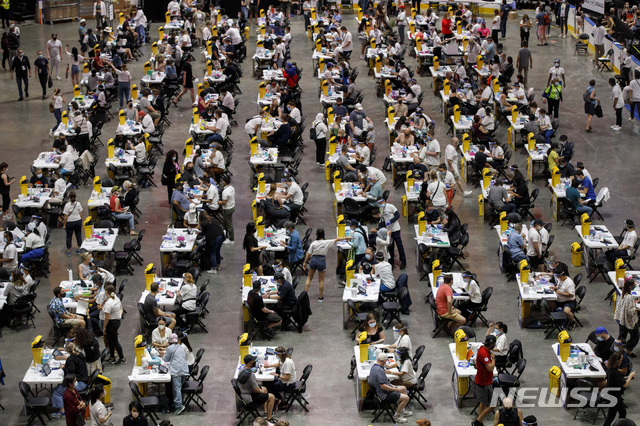 FILE - In this Sunday, June 27, 2021 file photo, people receive a dose of the COVID-19 vaccine at a mass vaccination clinic at Scotiabank Arena in Toronto. (Cole Burston/The Canadian Press via AP)