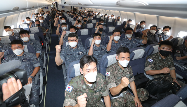 [서울=뉴시스] 18일 공군5공중기동비행단 주기장에 주기 되어 있는 공군 다목적공중급유수송기 시그너스(KC-330)에 청해부대 34진과 대체인력이 사용할 의무 및 각종 물자들을 적재 완료한 후 장병들이 파이팅 포즈를 취하고 있다. (사진=국방부 제공) 2021.07.18. photo@newsis.com *재판매 및 DB 금지