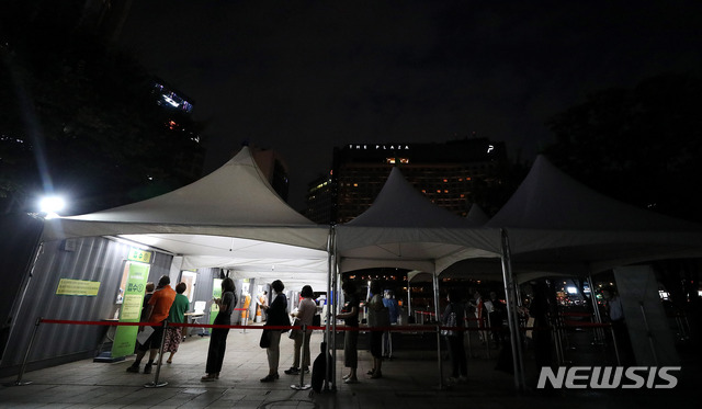 [서울=뉴시스] 추상철 기자 = 코로나19 확진자가 늘고 있는 22일 오후 서울 중구 서울광장에 마련된 임시 선별진료소에서 늦은밤 코로나19 검사자들이 줄지어 서 있다. 2021.07.22. scchoo@newsis.com