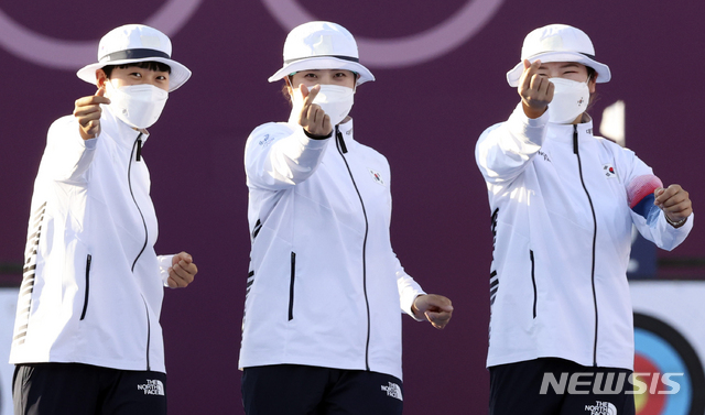 [도쿄(일본)=뉴시스] 최진석 기자 = 대한민국 양궁 대표팀 안산과 장민희 강채영이 25일 오후 일본 도쿄 유메노시마 양궁장에서 열린 2020 도쿄올림픽 양궁 여자단체전 우승, 시상대에 오르며 손가락 하트를 하고 있다. 2021.07.25. myjs@newsis.com