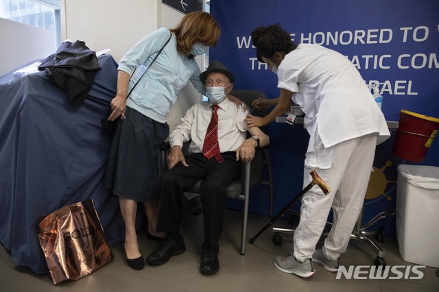 Yehuda Widawsky, a 102-year-old Holocaust survivor, receives a third Pfizer-BioNTech COVID-19 vaccine at a hospital in Tel Aviv, Israel, Sunday, Aug. 1, 2021. Israeli health authorities began administering coronavirus booster shots Friday to people over 60 who've already received both doses of a vaccine, in a bid to combat a recent spike in cases. (AP Photo/Sebastian Scheiner)
