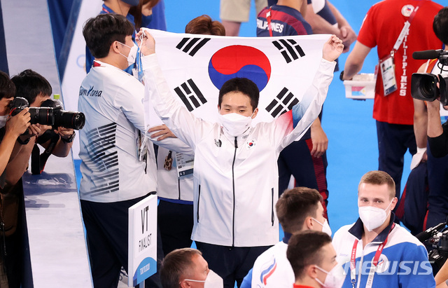 [도쿄(일본)=뉴시스] 최진석 기자 = 신재환이 2일 일본 도쿄 아리아케 체조경기장에서 열린 '2020 도쿄올림픽' 남자 도마 결승에서 연기를 마친 뒤 태극기를 펼쳐들고 있다. 2021.08.02. myjs@newsis.com
