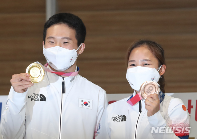 [인천공항=뉴시스] 고승민 기자 = 도쿄올림픽 남자 및 여자 기계체조에서 금, 동메달을 딴 신재환, 여서정이 3일 인천국제공항 2터미널을 통해 귀국, 포즈를 취하고 있다. 2021.08.03. kkssmm99@newsis.com