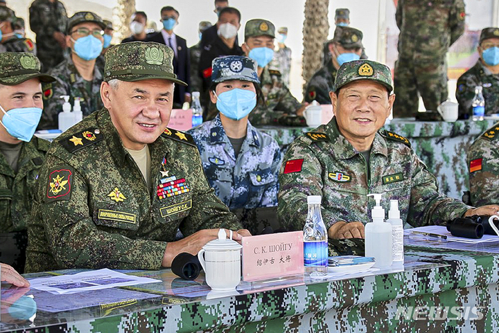 [닝샤=AP/뉴시스]세르게이 쇼이구 러시아 국방장관(앞줄 왼쪽)과 웨이펑허 중국 국방장관이 지난해 8월 13일 중국 내몽고 닝샤 자치구에서 실시된 합동군사훈련을 지켜보고 있다. 