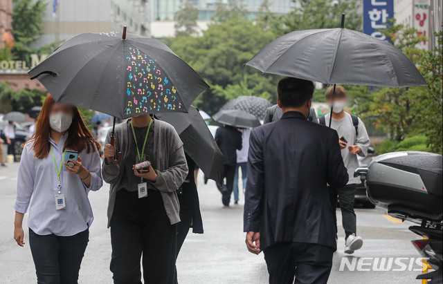 [서울=뉴시스] 권창회 기자 = 전국적으로 비가 내린 지난 27일 오후 서울 여의도공원 인근에서 시민들이 우산을 쓰고 이동하고 있다. 2021.08.27. kch0523@newsis.com