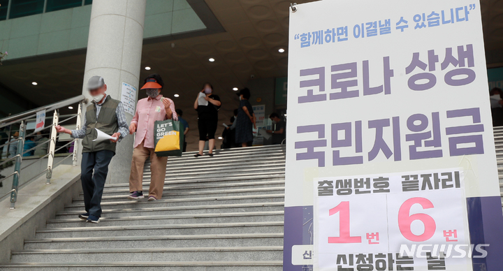 [전주=뉴시스] 김얼 기자 = 코로나 상생 국민지원금 현장 신청 첫날인 13일 전북 전주시 완산구 서신동 주민센터 입구에 안내문이 붙어 있다. 2021.09.13. pmkeul@newsis.com