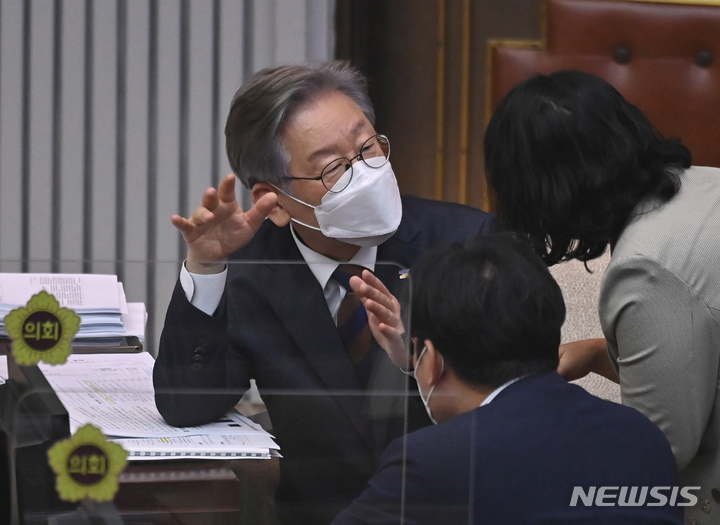 [수원=뉴시스] 김종택기자 = 더불어민주당 대선 주자인 이재명 경기지사가 15일 오전 경기도 수원시 경기도의회에서 열린 제354회 임시회 제4차 본회의에 출석해 도의원들과 대화하고 있다. 2021.09.15. jtk@newsis.com