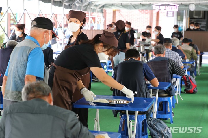 [서울=뉴시스] 박진희 기자 = '명동밥집' 자원봉사자들이 24일 오전 서울 중구 옛 계성여고에 위치한 급식소에서 점심 배식을 하고 있다. 명동밥집은 천주교서울대교구에서 노숙인을 위해 운영하는 무료급식소이다. 2021.09.25. pak7130@newsis.com