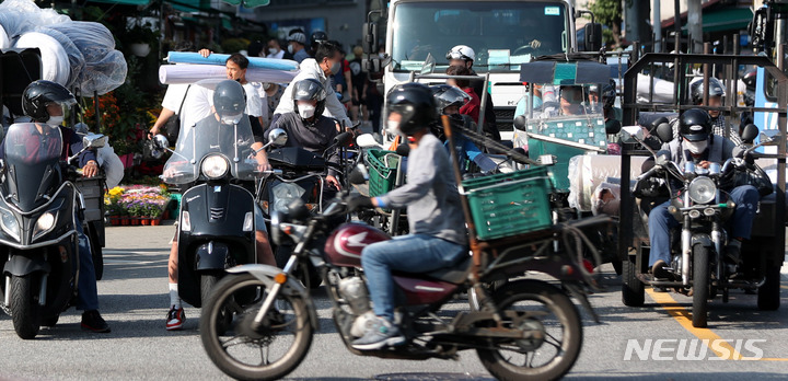 [서울=뉴시스] 추상철 기자 = 서울 종로구 동대문종합시장 인근에서 배달 종사자가 각종 물품을 배달하고 있다. 2021.09.30. scchoo@newsis.com