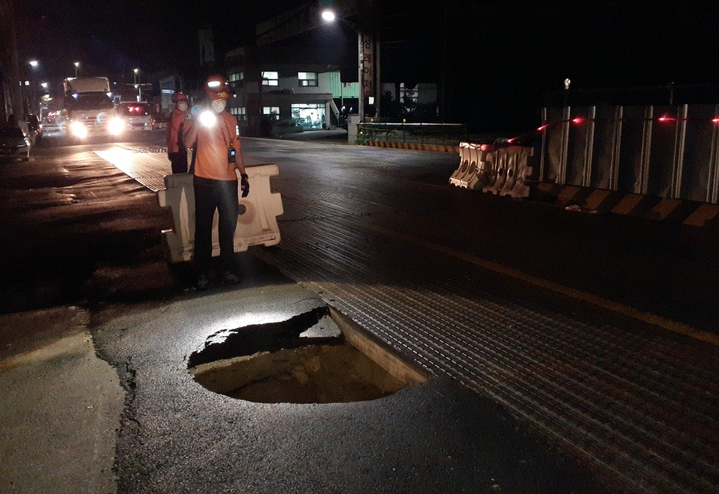 [부산=뉴시스] 6일 오전 3시 10분게 부산 사상구 학장동의 한 도로에서 지름 1.5m, 깊이 3m 크기의 땅꺼짐(싱크홀) 현상이 발생했다. (사진=부산소방재난본부 제공) *재판매 및 DB 금지