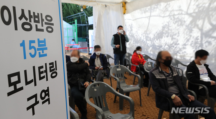 [서울=뉴시스] 권창회 기자 = 국내 코로나19 백신 접종 완료율이 70%를 넘어선 24일 오전 서울 영등포구 찾아가는 백신접종센터에서 외국인들이 얀센 백신 접종 후 이상반응을 살피기 위해 대기하고 있다. 2021.10.24. kch0523@newsis.com