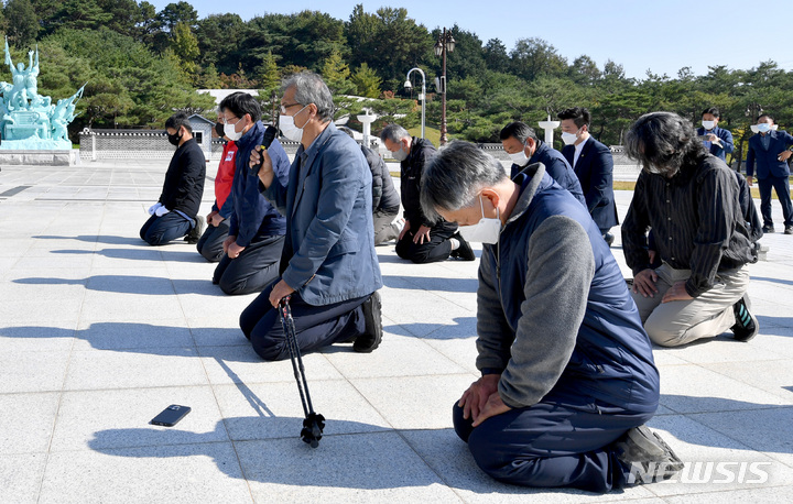[광주=뉴시스] 변재훈 기자 = 전두환 국립묘지 안장 반대 활동을 펼치고 있는 경남 합천 시민사회단체 회원들이 25일 광주 북구 운정동 국립 5·18민주묘지 추모탑 앞에서 분향을 마친 뒤 무릎 참배를 하고 있다. 2021.10.25. wisdom21@newsis.com