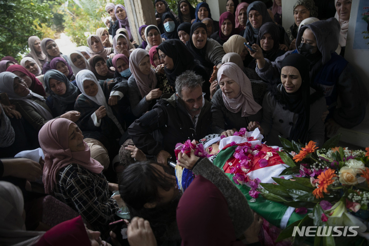 [라말라(서안지구)=AP/뉴시스] 예루살렘 구시가지에서 지난 9월에 이스라엘군을 공격하다 살해된 이스라 카지미아 소녀의 시신이 11월 20일 반환된 후 이를 둘러싸고 슬퍼하는 가족들과 서안지구 콰바티야 마을의 주민들.