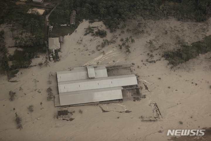 [자바(인도네시아)=AP/뉴시스]5일 인도네시아 자바섬 동부에 위치한 스메루 산이 분화한 가운데 한 공장이 화산재로 덮여 있다. 2021.12.06.