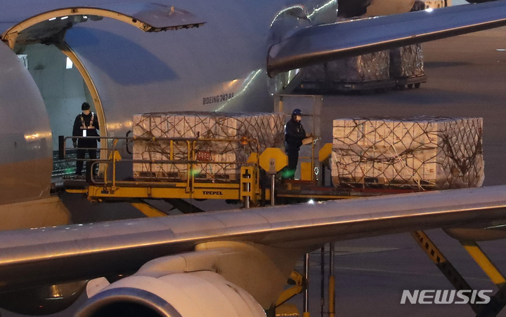 [인천공항=뉴시스] 개별 계약한 코로나19 화이자 백신 248만3000회분이 지난 6일 오후 인천국제공항 화물터미널에 도착해 백신수송 관계자들이 수송작업을 하고 있다. 2021.12.06. 20hwan@newsis.com