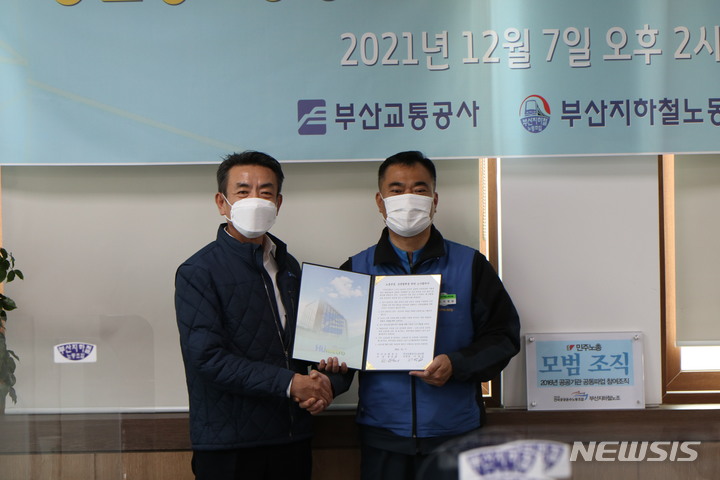 [부산=뉴시스] 한문희 부산교통공사 사장(사진 왼쪽)과 서영남 부산지하철노동조합 위원장이 7일 노사 합의서 체결 후 기념사진을 촬영하고 있다. (사진=부산지하철노동조합 제공)