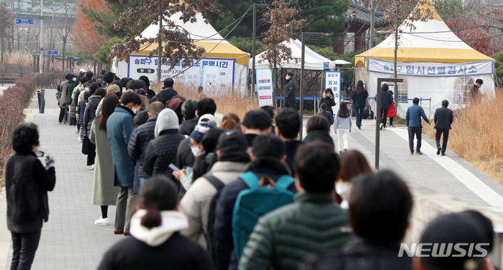 [서울=뉴시스] 추상철 기자 = 지난 9일 오후 서울 송파구 문정도시개발구역 광장 임시선별검사소에서 시민들이 코로나19 검사를 받기 위해 줄지어 서 있다. 2021.12.09. scchoo@newsis.com
