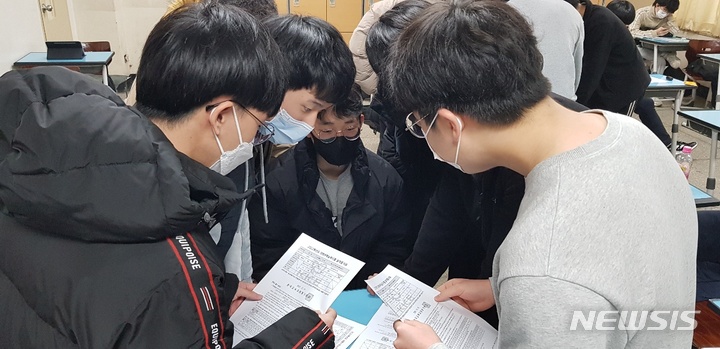 [청주=뉴시스] 김재광 기자 = 한국교육과정평가원이 지난 10일 오전 2022학년도 대학수학능력시험(수능)성적표를 전국 수험생에게 배부한 가운데 충북 청주 세광고등학교 학생들이 성적표를 보고 있다. 2021.12.11. kipoi@newsis.com