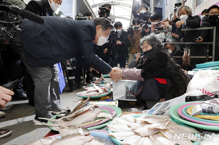 [포항=뉴시스] 최동준 기자 = 이재명 더불어민주당 대선 후보가 13일 경북 포항시 죽도시장을 방문해 상인 어르신과 인사하고 있다. 2021.12.13. photocdj@newsis.com