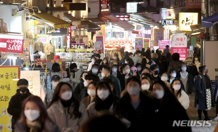 [서울=뉴시스] 김병문 기자 = 정부가 '위드코로나'를 중단하고 사적 모임과 다중이용시설 운영을 제한하는 조치를 발표한 16일 오후 서울 마포구 홍대거리가 시민들로 붐비고 있다. 정부는 오는 18일부터 내달 3일까지 사적 모임은 4인까지, 다중이용시설 영업은 위험도 분류에 따라 오후 9~10시까지 제한하는 대책을 시행한다고 발표했다. 2021.12.16. dadazon@newsis.com