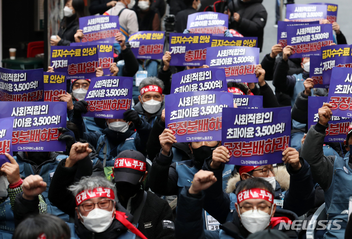 [서울=뉴시스] 조성우 기자 = 진경호 전국택배노동조합 위원장 등 조합원들이 20일 오후 서울 중구 CJ대한통운 본사 앞에서 열린 CJ대한통운 전국대표자 총파업 선포대회에서 구호를 외치고 있다. 2021.12.20. xconfind@newsis.com