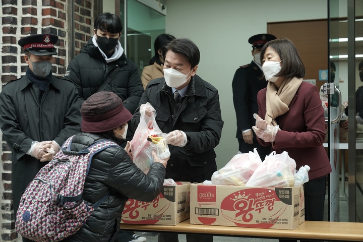 [서울=뉴시스] 최진석 기자 = 안철수 국민의당 대선 후보와 부인 김미경 교수가 24일 부산 진구 구세군교회 앞에서 점심식사 배급 봉사를 하고 있다. (사진=국민의당 제공) 2021.12.24. photo@newsis.com *재판매 및 DB 금지