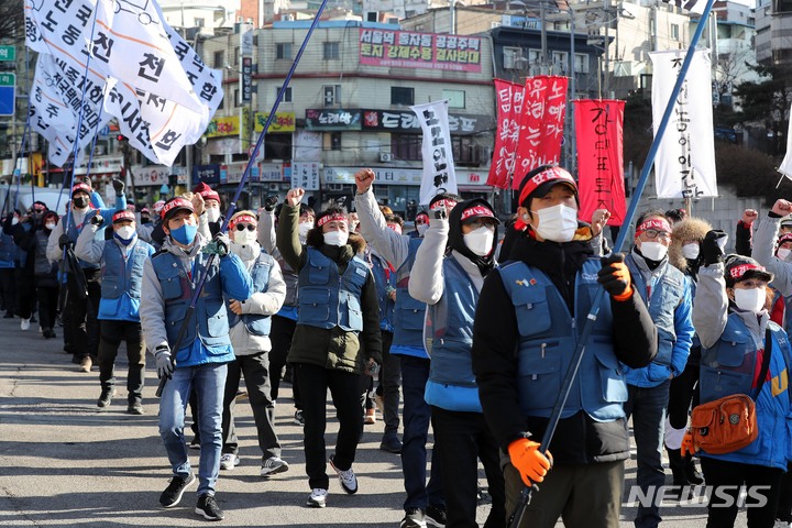 [서울=뉴시스] 백동현 기자 = 민주노총 서비스연맹 전국택배노동조합 조합원들이 4일 오후 서울 중구 CJ 본사 앞에서 CJ대한통운 총파업 결의대회를 마치고 CJ대한통운 본사 방향으로 행진하고 있다. 2022.01.04. livertrent@newsis.com