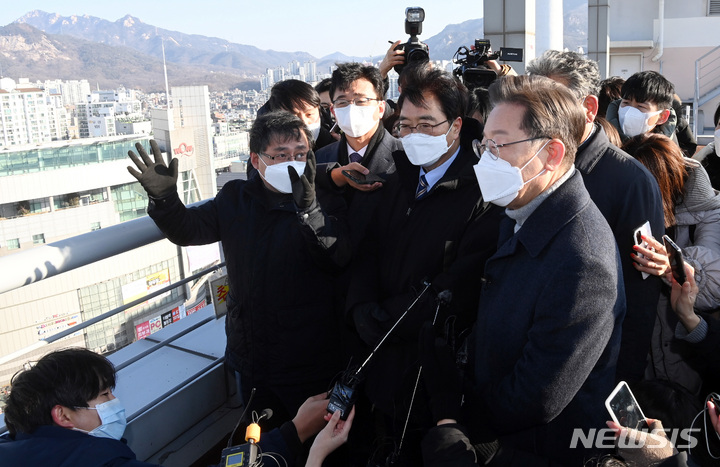 [서울=뉴시스] 국회사진기자단 = 이재명 더불어민주당 대선 후보가 13일 서울 노원구 한 빌딩 옥상에서 부동산 정책발표 전 노후 아파트 단지를 살펴보고 있다. 2022.01.13. photo@newsis.com