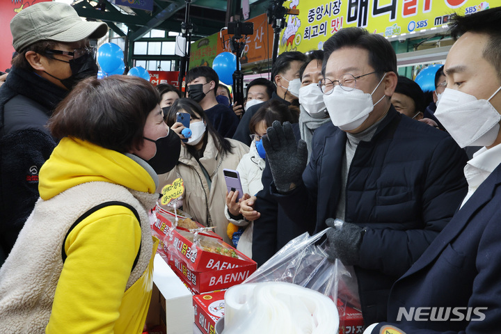 [강릉=뉴시스] 최동준 기자 = 이재명 더불어민주당 대선 후보가 16일 강원 강릉 중앙성남전통시장을 방문해 상인들과 인사하고 있다. (공동취재사진) 2022.01.15. photo@newsis.com