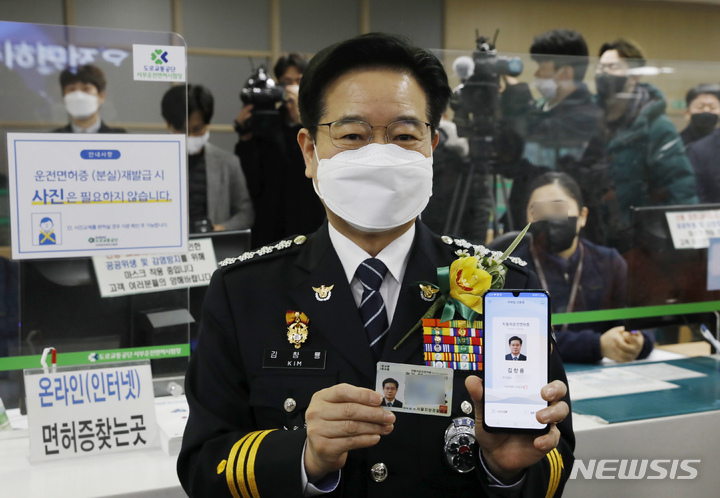 [서울=뉴시스] 고승민 기자 = 27일 서울 서부운전면허시험장에서 열린 모바일 운전면허증 개통식에서 김창룡 경찰청장이 모바일 운전면허증을 발급받아 들어보이고 있다. 2022.01.27. kkssmm99@newsis.com
