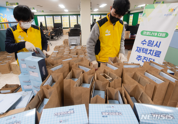 [수원=뉴시스] 김종택기자 = 코로나19 재택치료자가 역대 최고치를 기록한 9일 경기도 수원시청에서 관계자들이 재택치료자들에게 지급할 물품을 점검하고 있다. 10일부터 코로나19 증상이 없거나 경미한 재택치료 환자는 정부나 의료기관의 관리감독 없이 스스로 건강상태를 체크하고 자가격리 지침도 알아서 지키는 시스템으로 전환된다. 2022.02.09.jtk@newsis.com