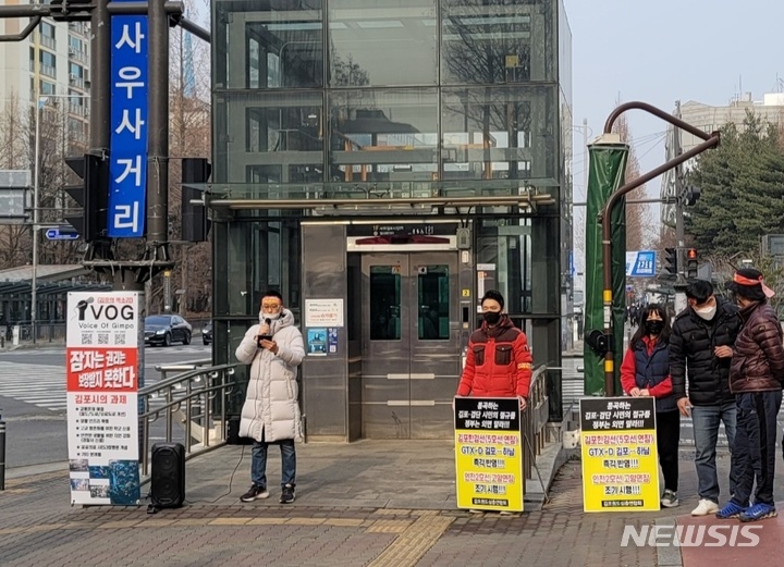 [김포=뉴시스] 정일형 기자 = 김포검단시민연대, 김포원도심총연합회, 인천검단신도시연합회는 13일 오후 김포골드라인 사우역 3번출구에서 'GTX-D·5호선 연장, 조기착공'공동 입장문을 발표하고 있다. (사진은 김포검단시민연대 제공) 2022.02.13. jih@newsis.com