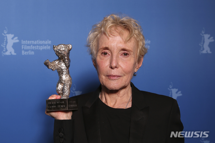 [베를린=AP/뉴시스]16일(현지시간) 베를린 국제영화제에서 최우수 감독상(은곰상)을 받은 프랑스의 클레어 데니스 감독이 트로피를 들고 포즈를 취하고 있다. 2022.2.17