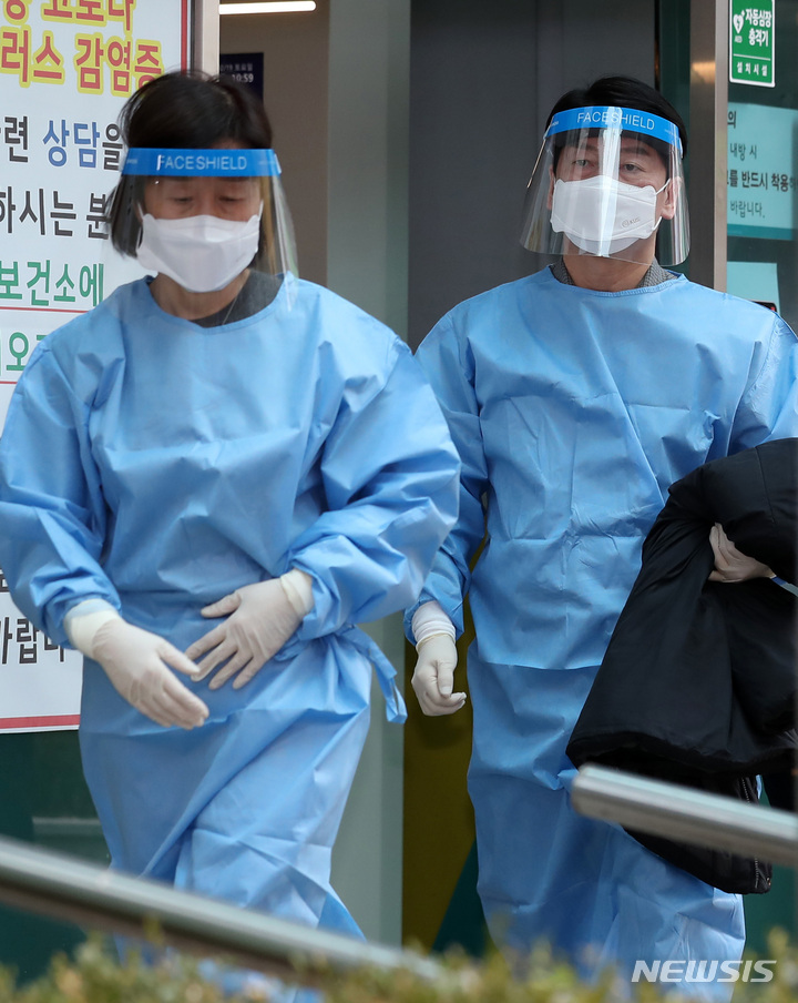 [서울=뉴시스] 이영환 기자 = 안철수(오른쪽) 국민의당 대선 후보와 부인 김미경 교수가 19일 오전 서울 중구보건소 선별진료소에서 의료 자원봉사를 하기위해 이동하고 있다. 2022.02.19. 20hwan@newsis.com