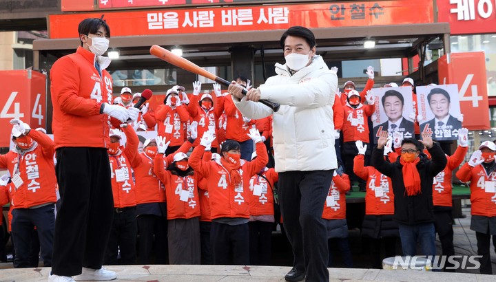[부산=뉴시스] 하경민 기자 = 안철수 국민의당 대선 후보가 22일 부산 중구 광복로 시티스팟에서 유세를 펼치기에 앞서 '4번 타자'를 강조하며 야구 배트를 휘두르는 퍼포먼스를 펼치고 있다. 2022.02.22. yulnetphoto@newsis.com
