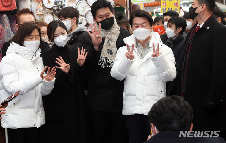 [부산=뉴시스] 하경민 기자 = 안철수 국민의당 대선 후보 부부가 22일 부산 중구 부평깡통시장을 방문, 시민들과 기호 4번을 만들며 기념사진을 찍고 있다. 2022.02.22. yulnetphoto@newsis.com