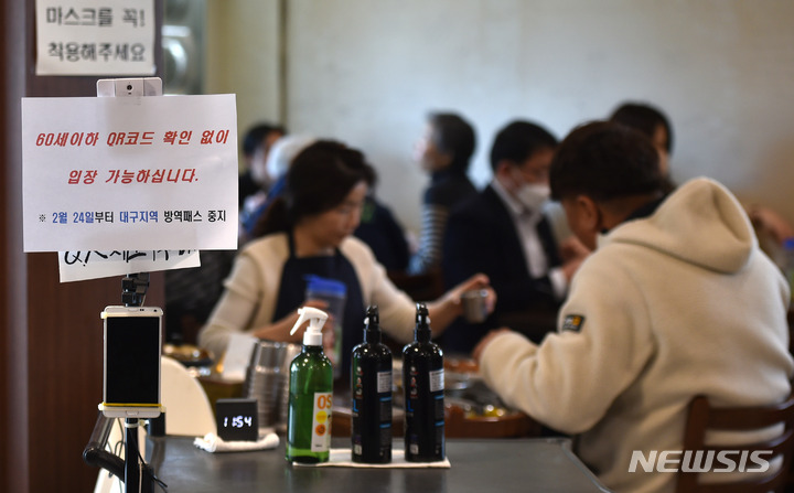 [대구=뉴시스] 이무열 기자 = 24일 오전 대구 중구의 한 식당에서 직원이 방역패스 안내문을 붙이고 있다. 전날 대구지법은 청소년 방역패스에 이어 60세 미만에 대한 식당·카페 방역패스 효력정지 결정을 내렸다. 2022.02.24. lmy@newsis.com