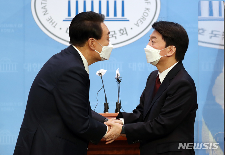 [서울=뉴시스] 김선웅 기자 = 야권 단일화에 전격 합의한 국민의힘 윤석열 대선 후보와 국민의당 안철수 대선 후보가 3일 오전 서울 여의도 국회 소통관에서 공동 기자회견을 마친 뒤 함게 손을 잡고 있다. (공동취재사진) 2022.03.03. photo@newsis.com