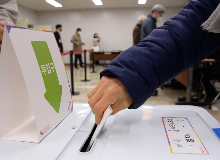 [전주=뉴시스] 김얼 기자 = 제20대 대통령 선거 사전투표 첫날인 4일 새벽 전북 전주시 완산구 서신동 주민센터 사전투표소에서 한 유권자가 투표함에 투표용지를 넣고 있다. 2022.03.04. pmkeul@nwsis.com