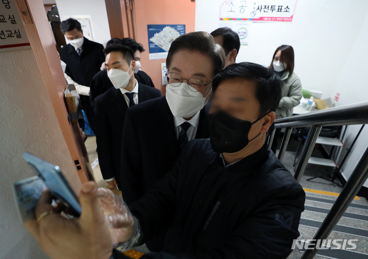 [서울=뉴시스] 국회사진기자단 = 이재명 더불어민주당 대선후보가 4일 오전 서울 중구 소공동 주민센터에서 사전투표를 마친 뒤 시민들과 셀카를 찍고 있다. 2022.03.04. photo@newsis.com