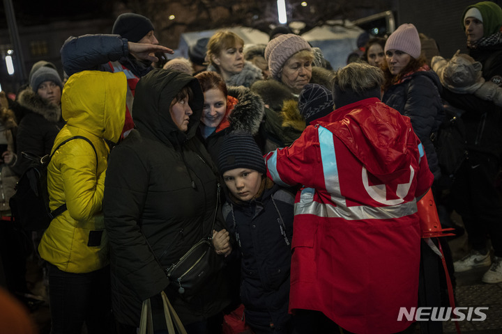 [리비우( 우크라이나)= AP/뉴시스] 리비우 시 철도역에 집결한 우크라이나 피난민들이 5일 폴란드로 타고갈 버스 앞에서 줄을 서고 있다.  