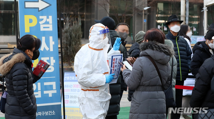 [서울=뉴시스] 이영환 기자 = 0시 기준 코로나19 신규 확진자가 21만716명 발생한 7일 오전 서울 송파구보건소 선별진료소를 찾은 시민들이 관계자에게 안내를 받고 있다. 2022.03.07. 20hwan@newsis.com